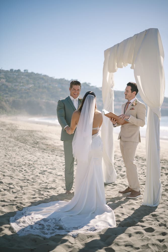 Smiling groom at wedding ceremony on Torrance Beach