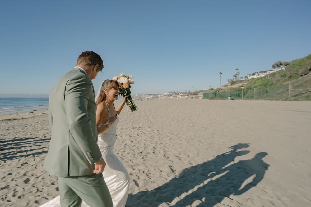 Bride and groom post wedding ceremony on Torrance Beach