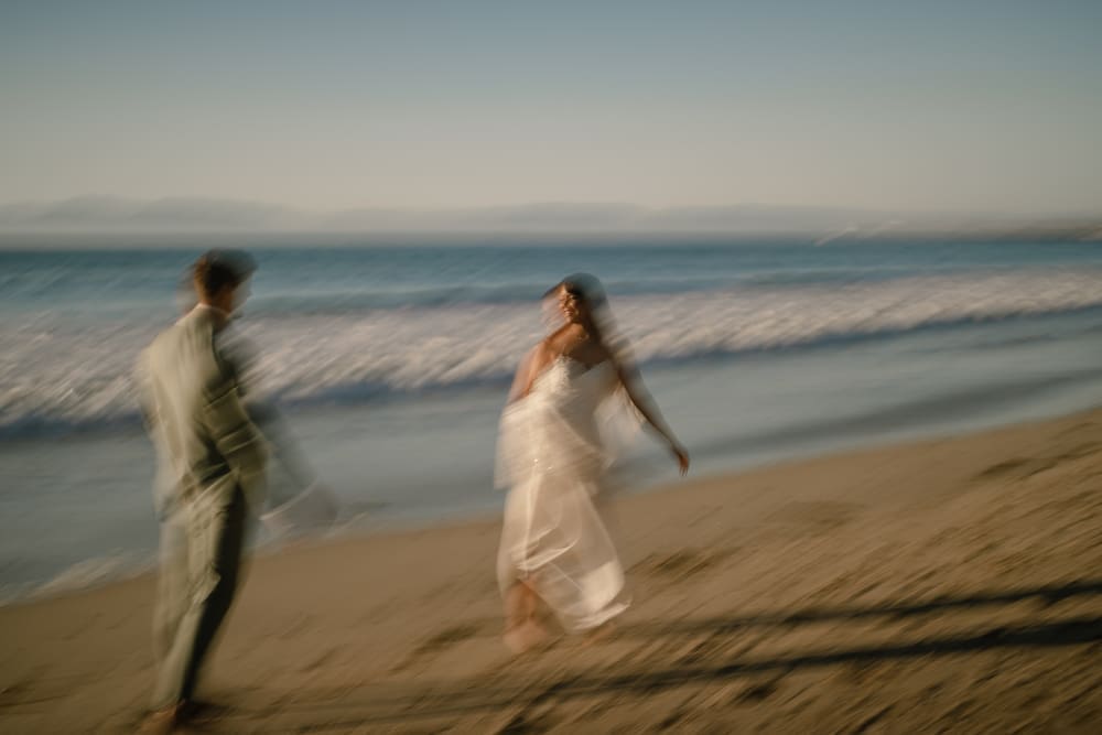 Playful bride and groom on Torrance Beach